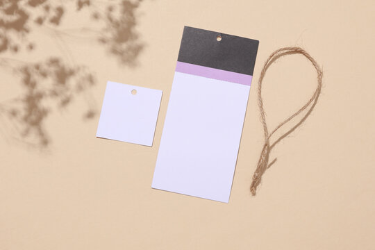 Disassembled tag with a string on a light background with a shadow