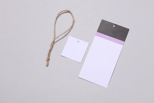 Disassembled tag with a string on a light background with a shadow