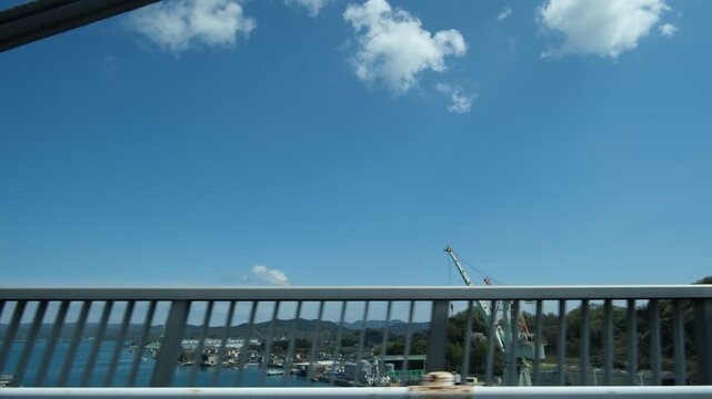 Driving Across Bridge with Structural Elements Passing in Front and Moving Landscape