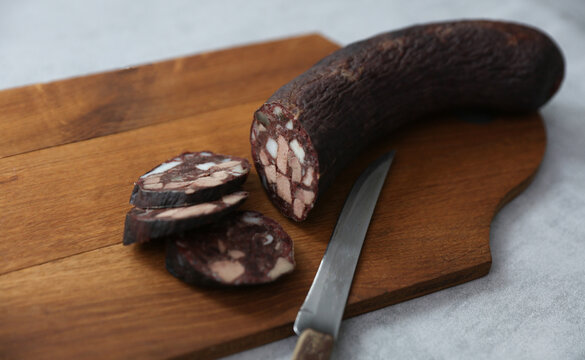 Blood sausage on a wooden cutting board