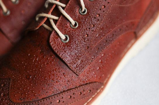 Brown leather brogue shoes with water droplets