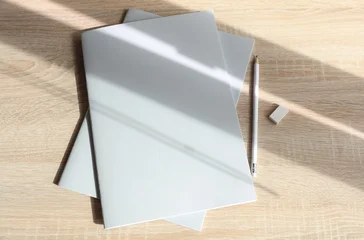 Corporate business books or notebooks with pencil on table with shadow. Mockup for design © splitov27