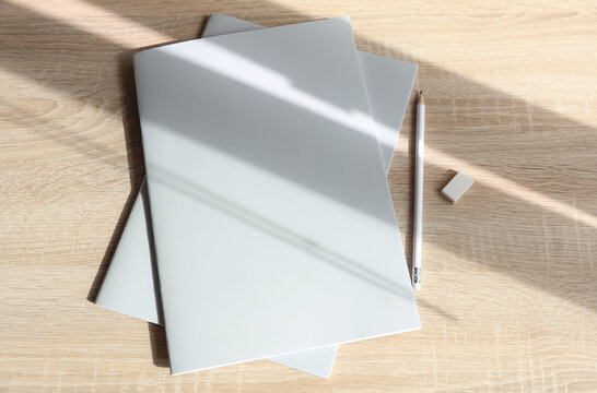 Corporate business books or notebooks with pencil on table with shadow. Mockup for design