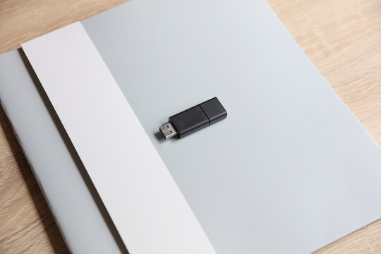 Notebook or business book with a USB flash drive on the table