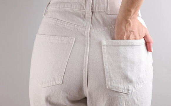 Slim sexy woman figure dressed in white denim jeans