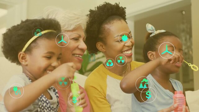 Family playing bubbles on sofa, blowing bubble wands, green energy icons covering lower frame