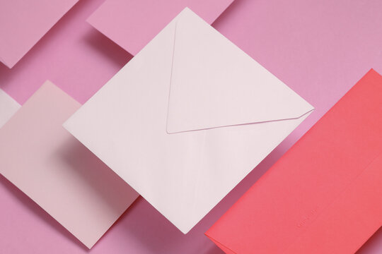 Set of floating envelopes and cards on a pink background. Invitations, corporate identification