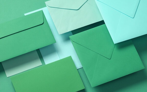 Set of floating green tones envelopes and cards on green  background. Invitations, corporate identification