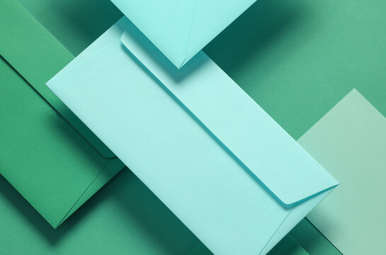 Set of floating green tones envelopes and cards on green  background. Invitations, corporate identification
