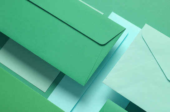 Set of floating green tones envelopes and cards on green  background. Invitations, corporate identification