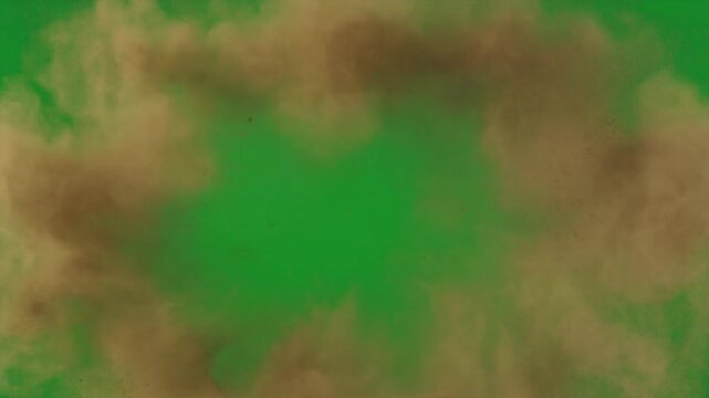 Dramatic brown dust cloud explosion or smoke burst effect on a vibrant green screen