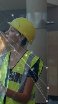 Vertical video: AR projection appearing, engineer turning and tapping globe nodes for construction