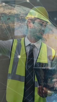 Vertical video: Site manager tapping tablet, pointing, globe overlay showing plant data over frame