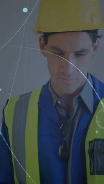 Vertical video: Construction worker checking tablet after HUD prompt, overlays marking safety data