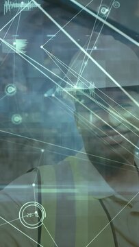 Vertical video: Site tech raising tablet, tapping AR nodes on transparent glass to verify beams