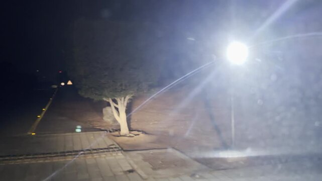 Stunning night road cutting through the quiet desert at The Ritz‑Carlton Al Wadi.