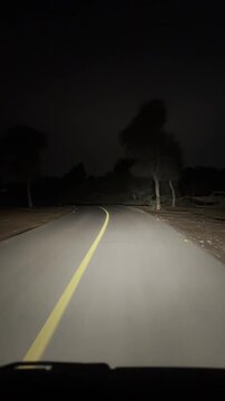 Stunning night road cutting through the quiet desert at The Ritz‑Carlton Al Wadi.