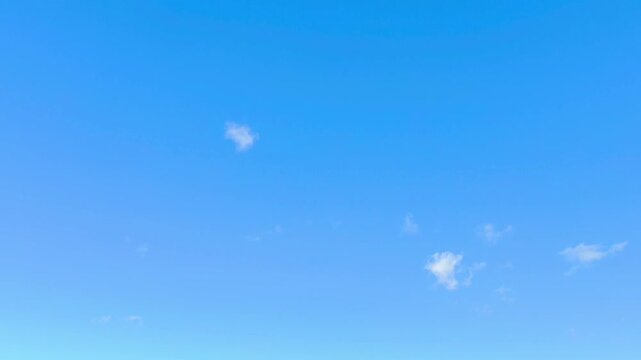 The blue sky with curious white clouds
