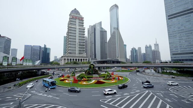 Urban traffic at Lujiazui roundabout bridge with Pudong financial skyscraper in Shanghai, China