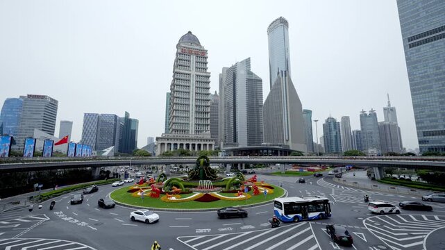 Urban traffic at Lujiazui roundabout bridge with Pudong financial skyscraper in Shanghai, China