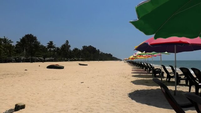 The beach with colorful umbrellas and chairs installed for tourists | Marari Beach, Alappuzha, Kerala, India