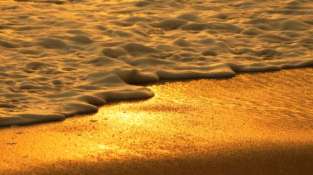 Ocean waves golden, beach sunset, washing ashore, beautiful peaceful nature
