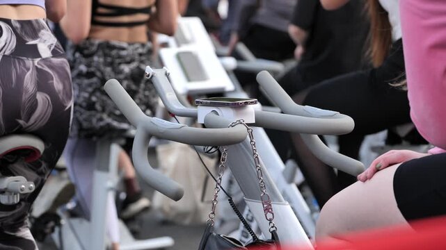 People exercising in group spinning class for fitness, health, and cardio workout