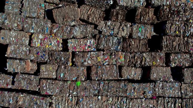Drone aerial view of large paper rolls inside a paper manufacturing facility. The scene highlights industrial production, storage, logistics, and factory layout from an overhead perspective.