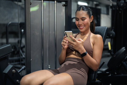 Thai Fitness Influencer Tracking Progress on Smartphone at Gym Gym Training Done Concept