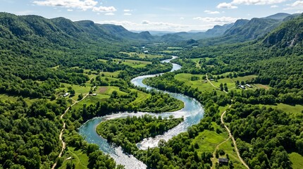 Aerial view of a serene river winding through a lush green valley surrounded by mountains © Arqam