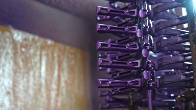 Close-up of pot handle components produced on an automated line inside a metal factory, showing precision manufacturing, durable materials, and industrial production process for cookware parts