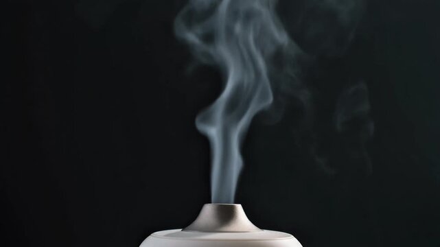 Graceful plume of white vapor rising from a sleek diffuser against a dark backdrop, creating a tranquil and serene atmosphere perfect for aromatherapy, relaxation, and home wellness