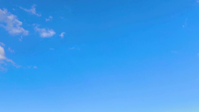 Almost cloudsless sky with clouds that grows