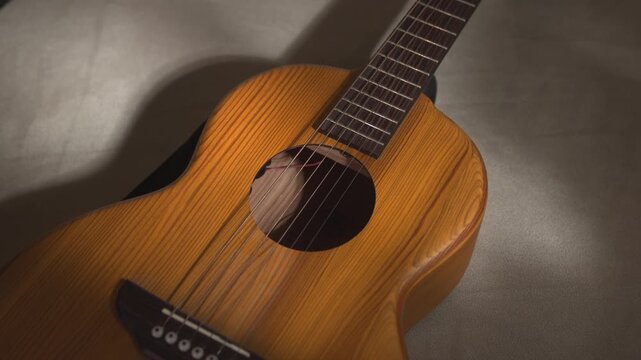 Warm Gentle Strumming. Casual Musical Setting Showcasing Strings And Wood Grain In Warm Ambient Light . Media