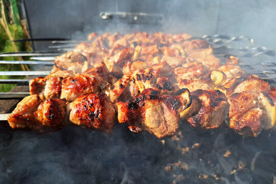 Grilled pork skewers on barbecue