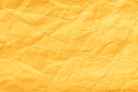 a solid background of yellow paper, heavily wrinkled with traces of kinks and kinks