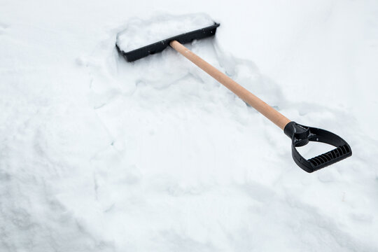 Snow removal equipment inserted into snow, cold weather chore