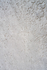 Fototapeta premium Close-up texture of a weathered grey concrete wall with peeling paint and cracked surface.