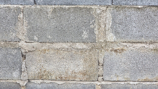 Close-up texture of a cinder block or concrete block wall. 