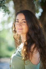 Fototapeta premium Portrait of a young beautiful brunette woman against the backdrop of the nature of northern Israel