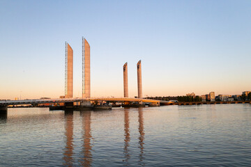Obraz premium Chaban-Delmas Lift Bridge at Golden Hour Reflected in Garonne River Bordeaux France