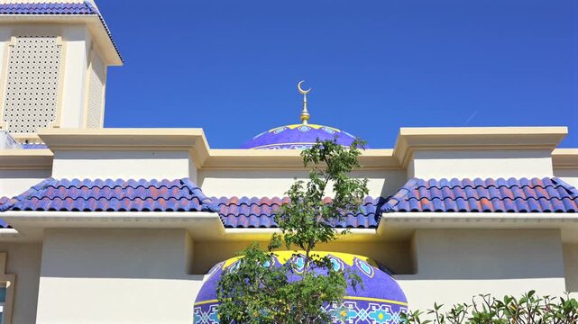 Elegant Mosque Structure With Vibrant Tiles And Lush Surroundings. Stunning Aerial View Of Ornate Mosque With Serene Mediterranean Ambiance Suitable For Travel And Architecture