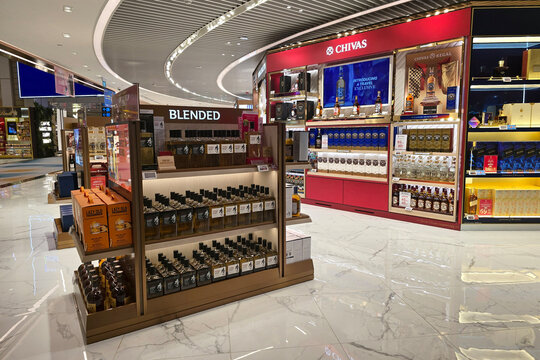 Changi, Singapore - Jan 14, 2026: Shelves of premium whisky including Suntory Toki and Chivas Regal on display at a luxury duty free retail outlet in Changi International Airport.