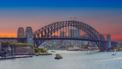 Obraz premium Panoramic view of Sydney Harbour and Circular Quay on a Beautiful Autumn Afternoon lovely colours of the sky in Sydney NSW Australia