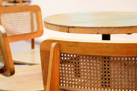 Detail image of Wicker chairs and table in a coffee shop. Furniture made of rattan.