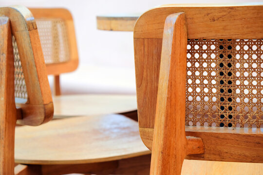 Detail image of Wicker chairs and table in a coffee shop. Furniture made of rattan.