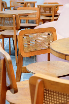 Detail image of Wicker chairs and table in a coffee shop. Furniture made of rattan.
