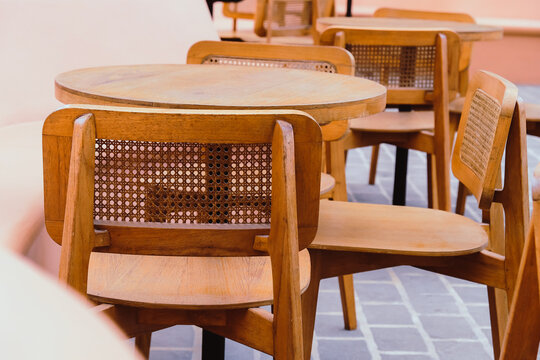 Detail image of Wicker chairs and table in a coffee shop. Furniture made of rattan.