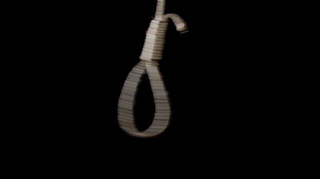 Rope noose swinging horizontally and slowly coming to rest on a dark background. Dramatic and symbolic imagery representing tension, danger, fear, or dark themes, suitable for cinematic and conceptual