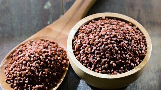 Bowl of buckwheat kasha on wooden table.